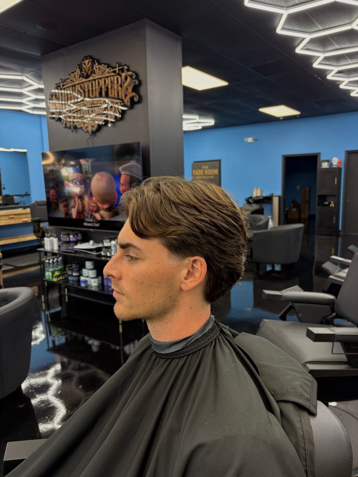 Juan Zapata, master barber in Davie, FL, photographed in the chair